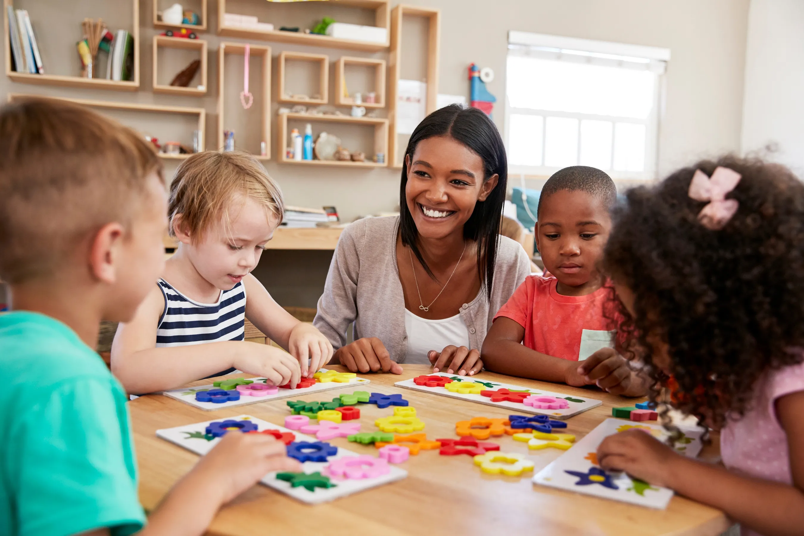 Teacher with children at a table
